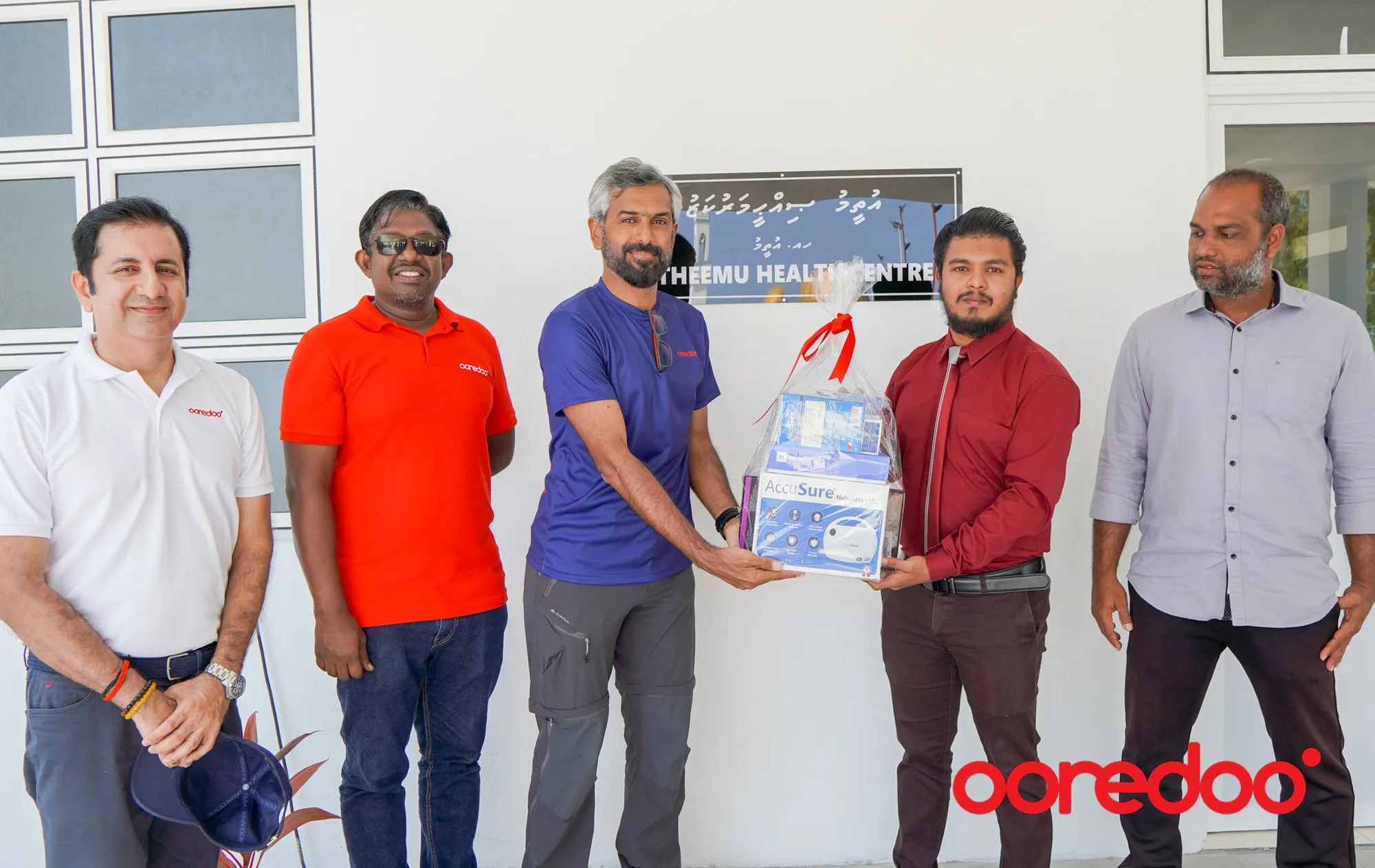 Ooredoo Maldives CEO handing over health test kits.