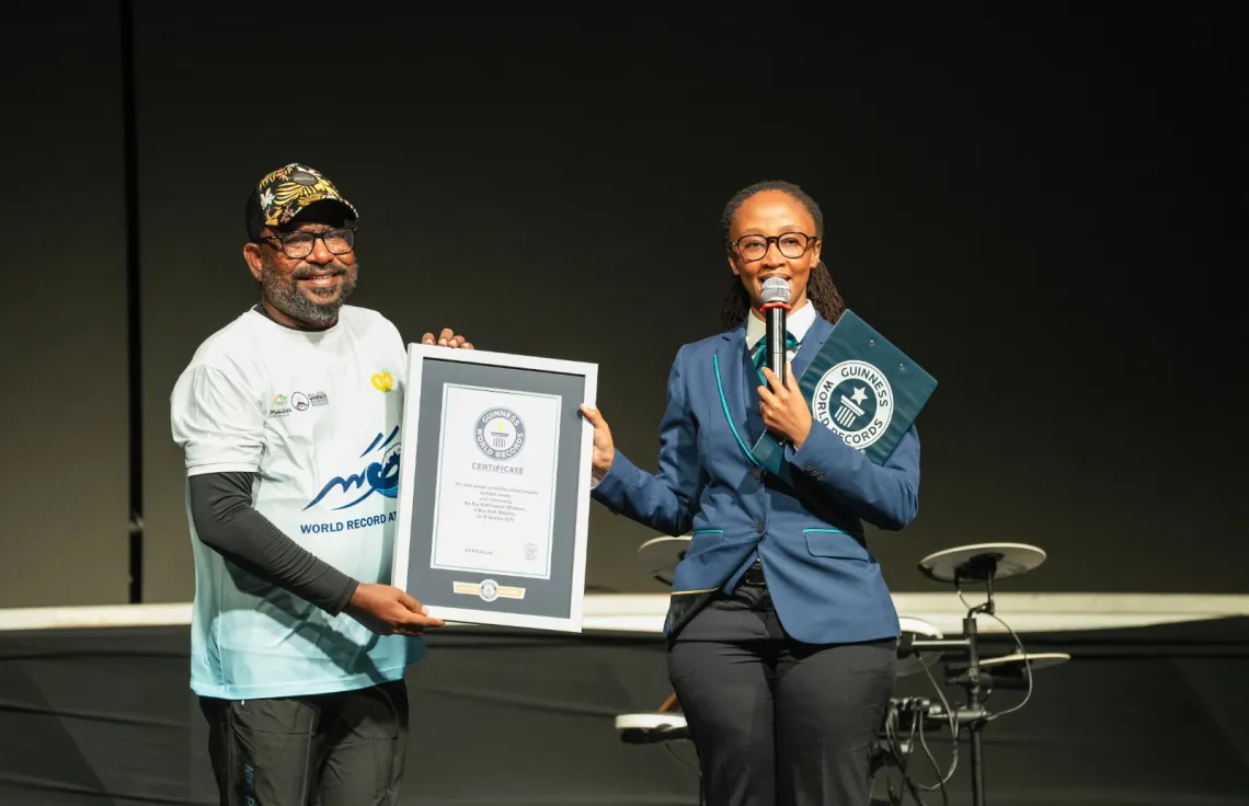 Guinness World Records official adjudicator presenting the certification plaque to the Baa Atoll Council