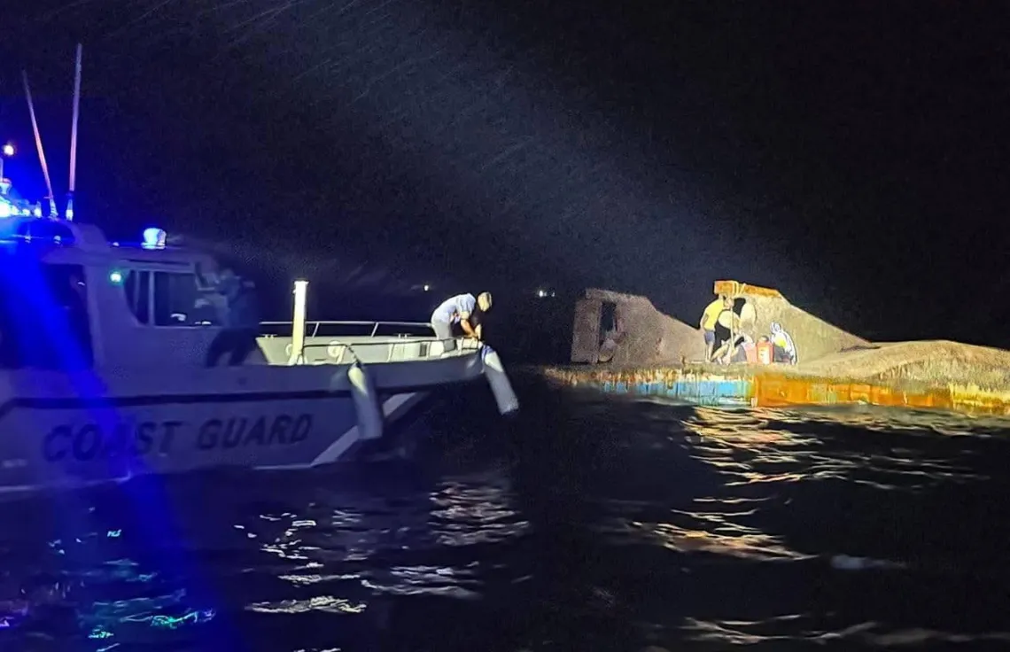 Maldives Coast Guard conducts rescue and recovery operations around the capsized landing craft