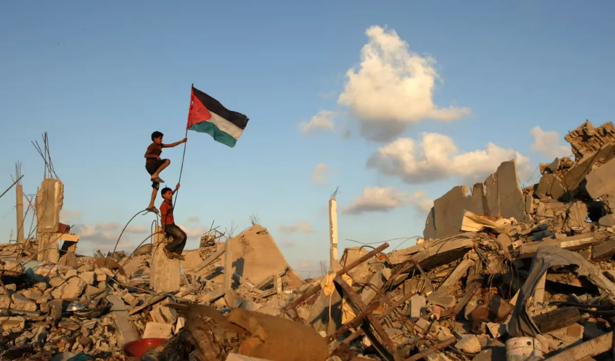Palestinian children plant their national flag among the rubble of a building which was destroyed during the Israeli army's attack in Khan Yunis, Gaza Strip. (Photo/ UPI /Landov / Barcroft Media)